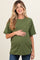 woman wearing a green short sleeve maternity top with a pocket and holding her baby bump