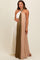 woman wearing a pleated halter neck maternity dress in white, olive green, and beige, showcasing her baby bump