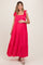woman wearing a bright pink sleeveless maternity maxi dress with tie straps and a visible baby bump