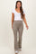 woman wearing a white short sleeve maternity top and beige flared maternity pants