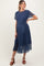 woman wearing a navy blue floral maternity dress with short sleeves and a waist tie, showcasing her baby bump