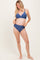 woman wearing a dark blue maternity bikini with a triangular top and high-waisted bottoms, showcasing her baby bump