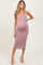 woman wearing a pink and white striped maternity dress with a fitted silhouette and a deep V-neck, showcasing her baby bump