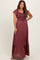 woman wearing a burgundy maternity maxi dress with ruffled sleeves and a smocked bodice, showcasing a baby bump
