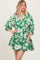 woman wearing a green floral print mini dress with a v-neckline and short puff sleeves