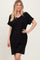 woman wearing a black short sleeve v-neck dress with rolled sleeves and a relaxed fit
