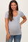 woman wearing a grey short sleeve maternity top and showing her baby bump