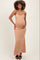 woman wearing a nude maternity maxi dress and holding her baby bump