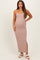 woman wearing a pink striped maternity maxi dress with spaghetti straps and a side slit, showing her baby bump