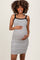 woman wearing a black and white striped maternity dress and holding her baby bump
