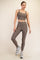 woman wearing a brown ribbed crop top and matching high-waisted leggings, paired with sporty sneakers