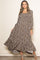 woman wearing a brown floral maxi dress with long sleeves and a tiered hemline