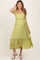woman wearing a light green maternity dress with ruffle straps and a tiered midi skirt, showcasing her baby bump