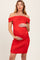 woman wearing a red off-shoulder maternity dress with gathered details and holding her baby bump