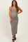 woman wearing a green ribbed maternity maxi dress and showing her baby bump