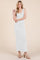 woman wearing a white sleeveless maxi dress with a fitted silhouette and a scooped neckline