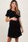 woman wearing a black short sleeve maternity dress and holding her baby bump