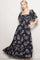 woman wearing a black floral maxi dress with puff sleeves and pockets
