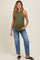 woman wearing a dark green ribbed maternity tank top and blue relaxed fit jeans, showing her baby bump