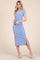 woman wearing a light blue short sleeve midi dress with a v-neck and side slit