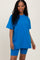 woman wearing a bright blue oversized t-shirt and matching bike shorts