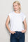 woman wearing a white oversized t-shirt with rolled short sleeves and blue high-waisted jeans