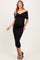 woman wearing a black off-the-shoulder maternity dress with a ruched design and a visible baby bump