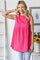 woman wearing a hot pink sleeveless tunic top with textured fabric and a flowy silhouette