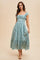woman wearing a light blue floral midi dress with ruffled sleeves and a fitted bodice