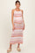 woman wearing a multicolored chevron patterned maternity maxi dress and showing her baby bump
