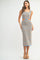 woman wearing a multicolored knit midi dress with cut-out details and a squared neckline