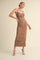 woman wearing a brown ruched midi dress with a sweetheart neckline and thin straps