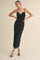 woman wearing a black ruched midi dress with spaghetti straps and a fitted silhouette