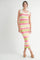 woman wearing a colorful striped knit midi dress with bow detail on the straps and platform sandals