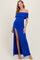 woman wearing a royal blue off-the-shoulder maxi dress with ruching and a thigh-high slit