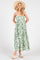 woman wearing a green floral maxi dress with spaghetti straps and a wide-brimmed hat