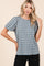 woman wearing a blue striped short sleeve top with puffed sleeves and a relaxed fit