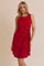 woman wearing a red sleeveless dress with a twisted knot detail at the waist