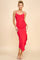 woman wearing a red ruched midi dress with spaghetti straps and a ruffled hem, standing against a neutral background