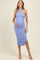 woman wearing a light blue maternity dress with ruching and a halter neckline, holding her baby bump