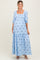 woman wearing a light blue maternity maxi dress with floral embroidery and puff sleeves, showcasing her baby bump