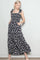 woman wearing a navy blue floral maxi dress with tie straps and pockets