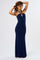 woman wearing a navy blue halter neck maxi dress with a keyhole detail and a decorative gold accent