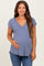 woman wearing a lavender maternity top with a v-neck and short sleeves, holding her baby bump