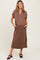 woman wearing a brown short sleeve maternity dress with pockets and side slits, holding her baby bump
