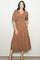 woman wearing a brown polka dot midi dress with puff sleeves and a tiered skirt