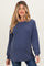 woman wearing a navy blue ribbed maternity sweater with long sleeves and a relaxed fit, baby bump visible