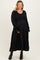 woman wearing a black long sleeve maternity dress with tiered skirt and a visible baby bump