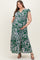 woman wearing a green floral maternity plus maxi dress with ruffled sleeves and a baby bump