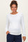 woman wearing a white long sleeve maternity top with a fitted design and a visible baby bump